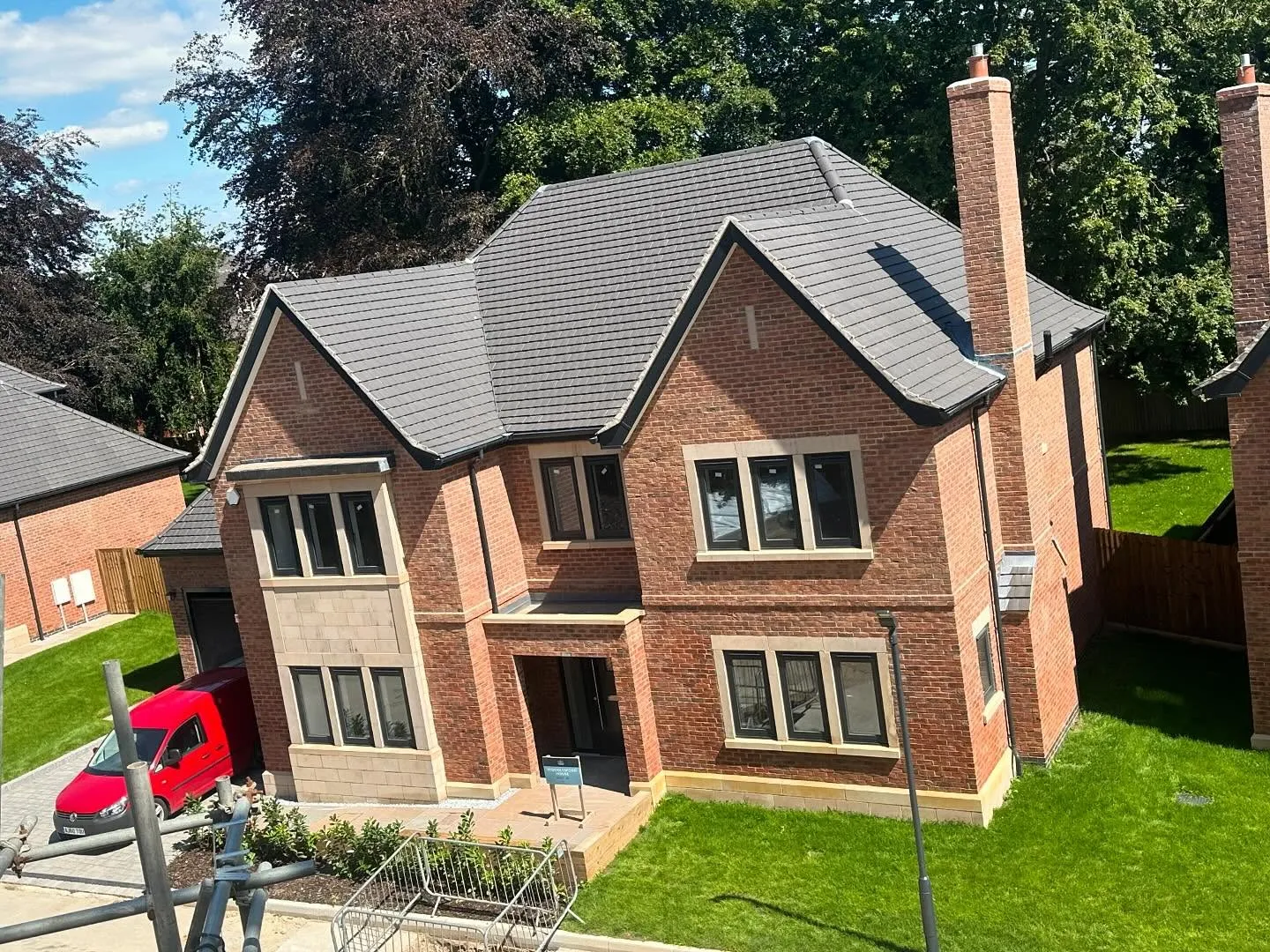 Brick house with pitched roofs and tall windows