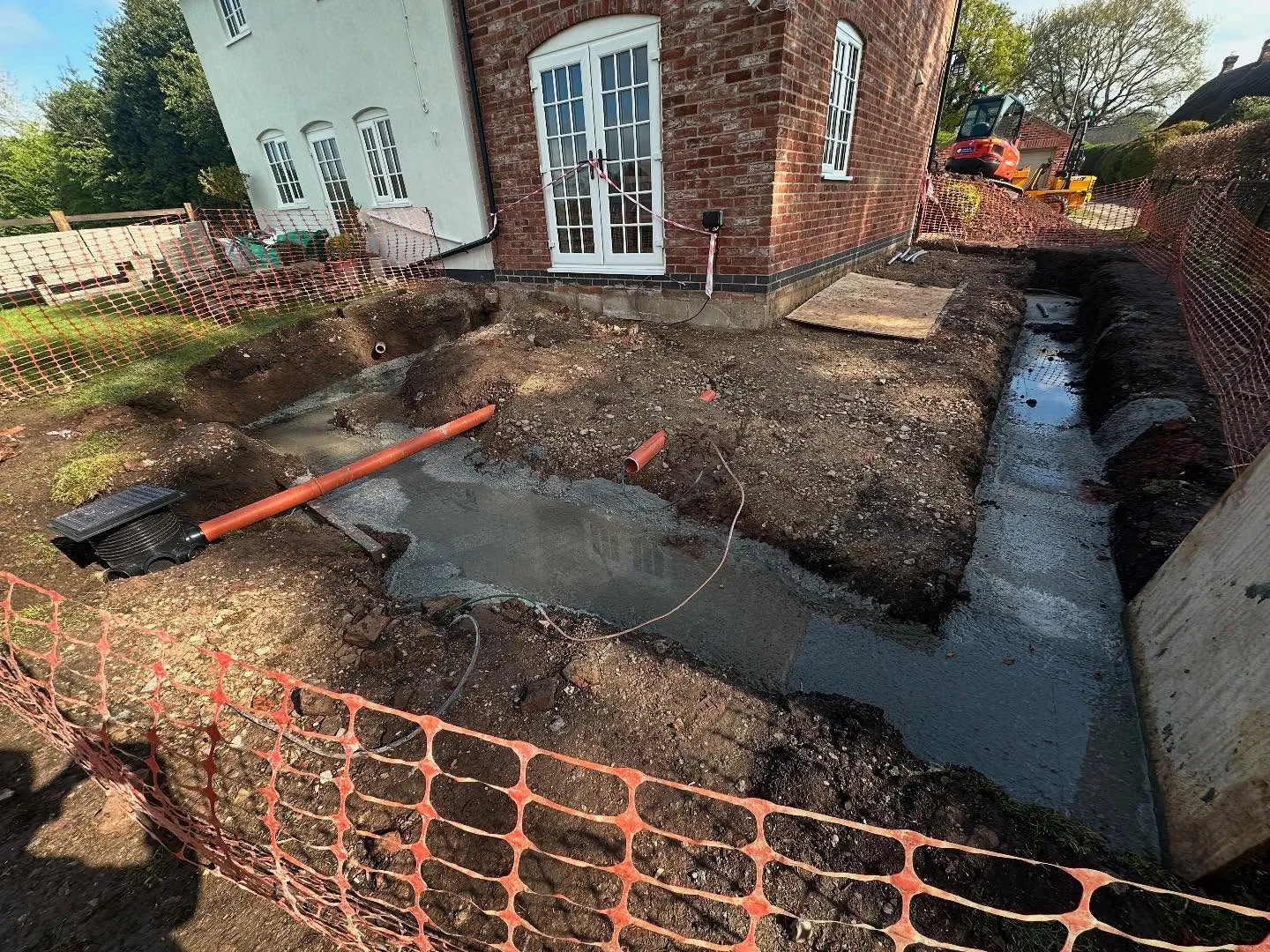 Excavated ground and drainage beside a house