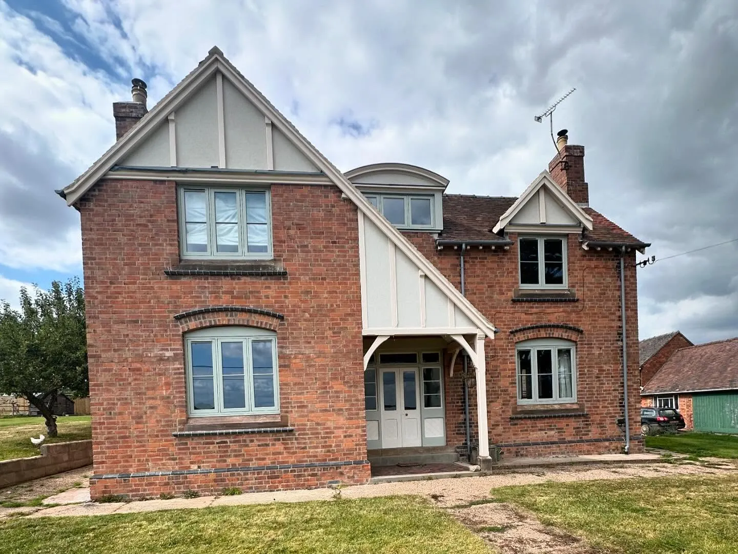 Brick house with gables and a timber porch