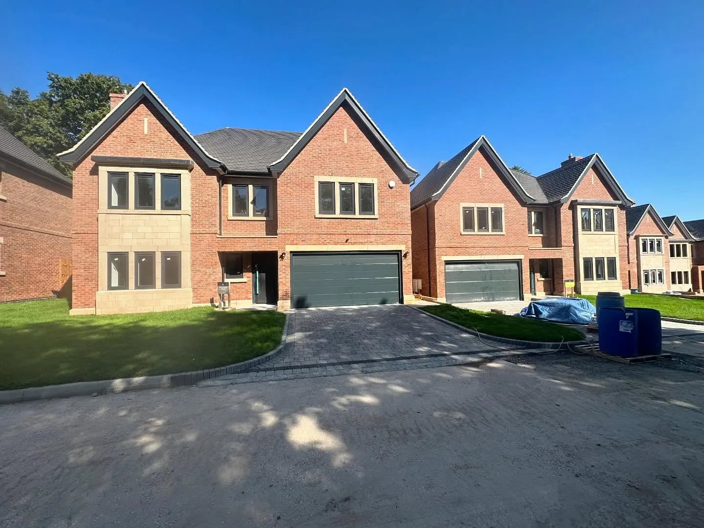 Brick houses with pitched roofs and garages